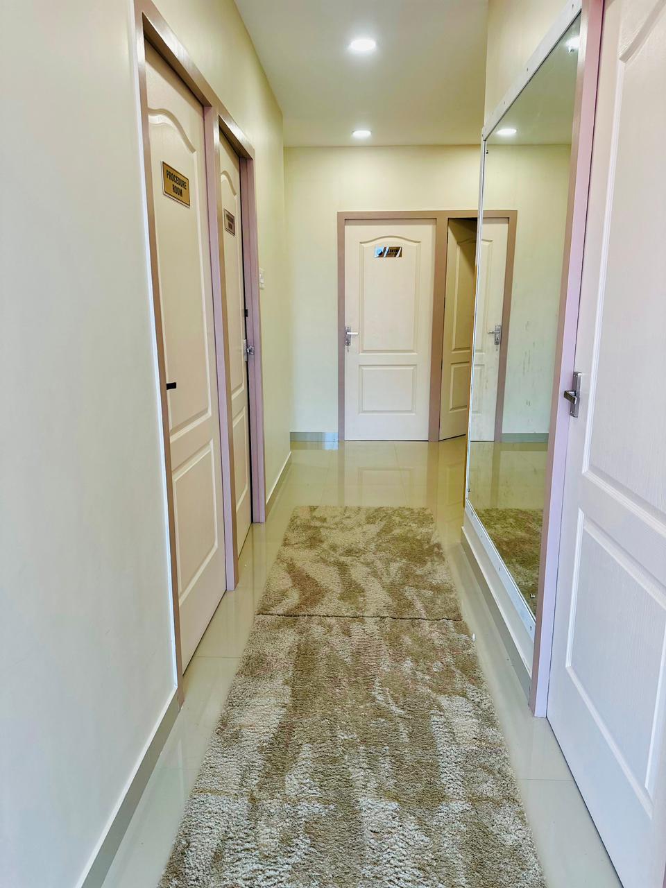 Hallway inside Silver Skin Clinic with mirror panel and carpet runner